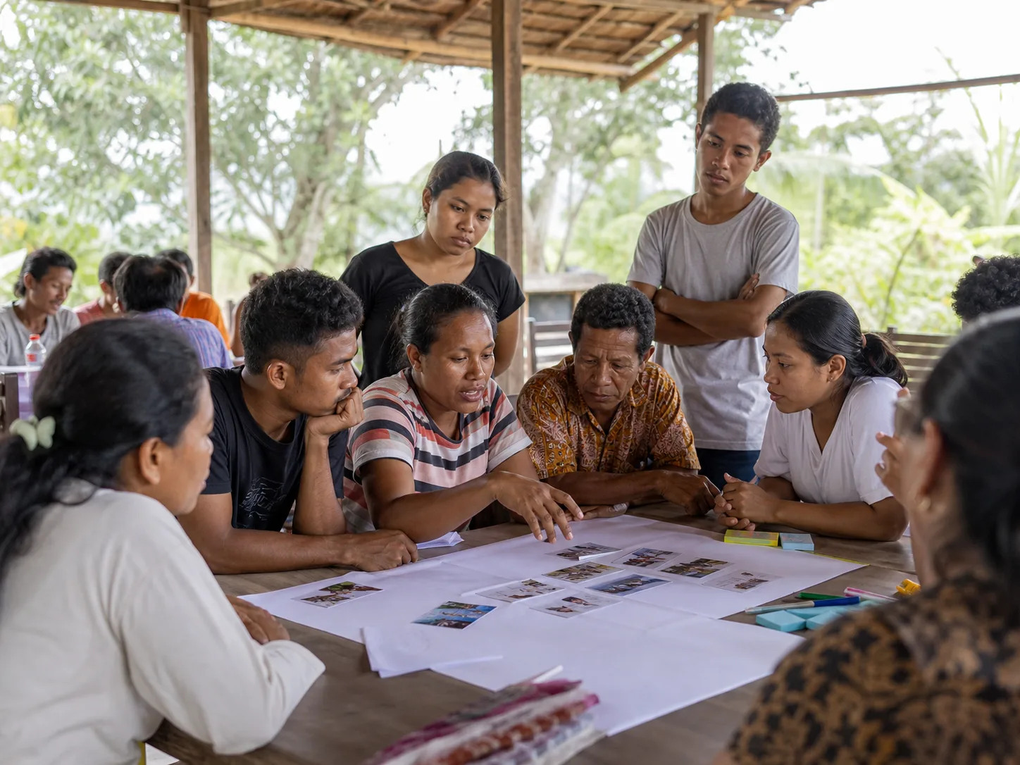 An Indonesian community group collaborating around practical workshop materials